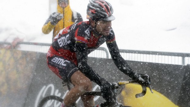Tough day: Cadel Evans rides through snow on Saturday's 20th stage of the Giro.