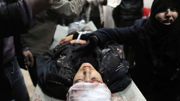 Shot by a sniper ... The mother of Mohammed Shawi, 15, reacts next to her son's body at a hospital in northwestern Syria.