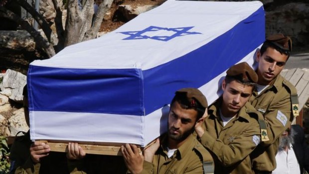Israeli soldiers carry the flag-draped coffin of Staff Sergeant Moshe Melako, 20, who was killed in Gaza.