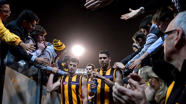 Strong start: Hawthorn fans and players celebrate after Friday night’s qualifying final win over Collingwood.