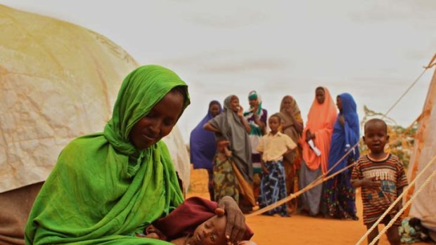 Lucky break ... Somalia refugee Ladhan Waraq lost one of her children to famine, but five-month-old Sahlan was given life-saving treatment after she was discovered by the Herald.