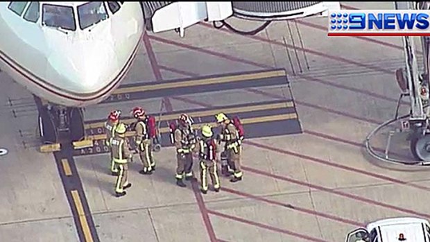Firefighters with the plane that made the emergency landing.