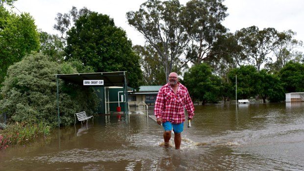 A man walks through flood water in Euroa.