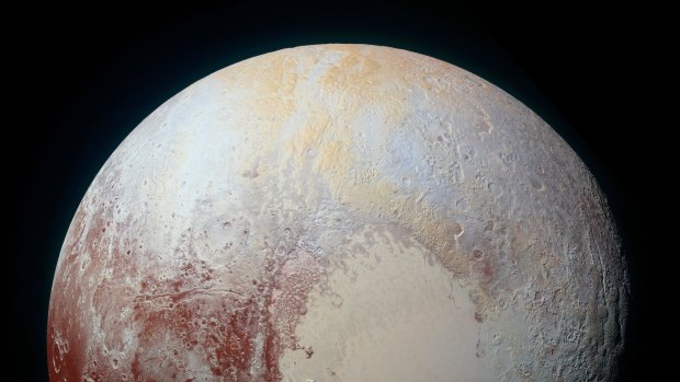 Pluto has reddish patches, showing likely interesting chemical activity on its frozen surface.