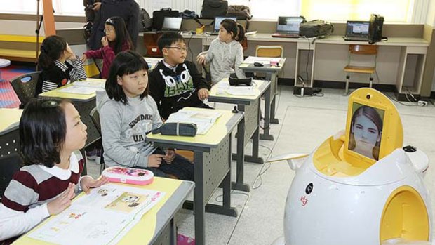 English-teaching robot "Engkey" stands in front of children at an elementary school in Daegu, 240 kms southeast of Seoul.