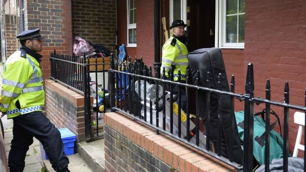 Police officers stand outside a block of flats in Greenwich following a raid in connection with the killing of a British soldier in nearby Woolwich, south east London May 23, 2013.