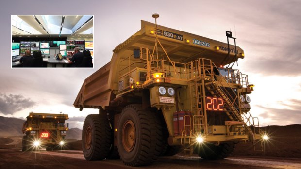 Rio Tinto's fleet of unmanned haulage trucks, monitored at the operations centre in Perth (inset).