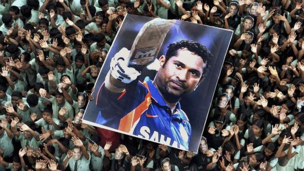 Indian students hold a poster of Indian cricketer Sachin Tendulkar after he batted for his landmark 100th century earlier this month.