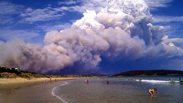 A fire at Forcett, 30km from Hobart, sends smoke over Park Beach. At nearby Carlton River residents were being told to evacuate.