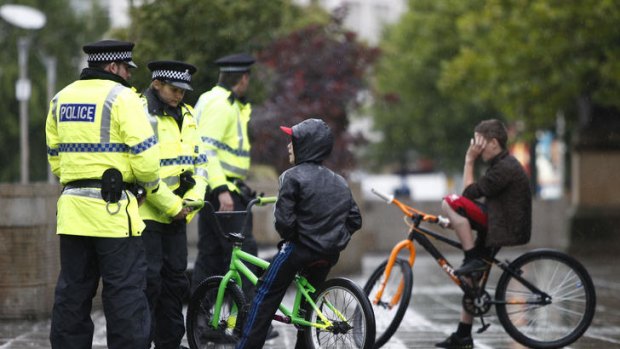 Police talk to children in Manchester.