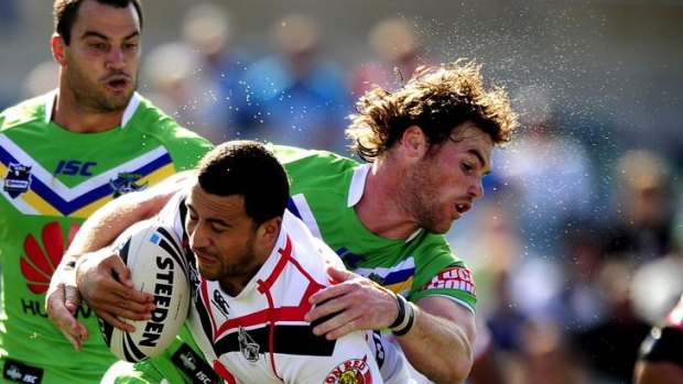 Sweat flies off Canberra's Joe Picker as he tackles New Zealand's Ben Matulino.