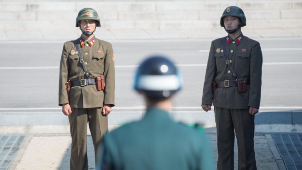 North and South Korean soldiers stand along the border in the demilitarized zone (DMZ) in Panmunjom, South Korea.