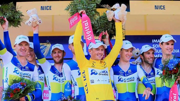 Simon Gerrans of Australia and Team Orica-GreenEDGE celebrates Gerrans' overall leader yellow jersey on the podium at the end of stage four of the 2013 Tour de France.
