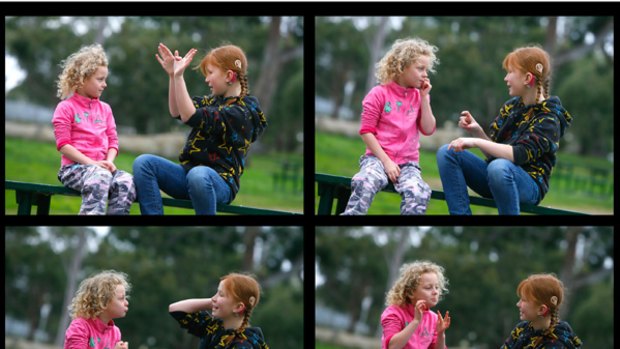 Five-year-old Kayla Trinder-Scacco and 10-year-old Sarah Keenan talk in Auslan.