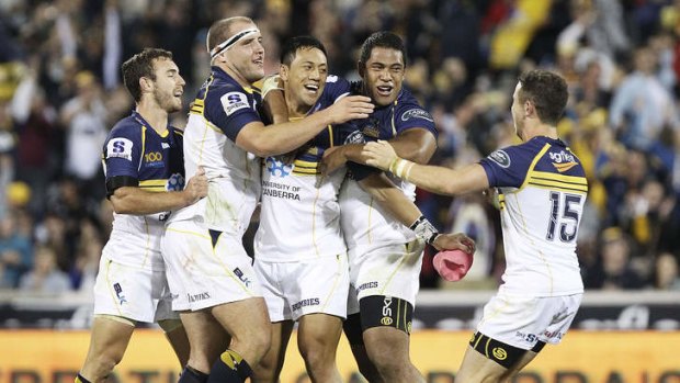 Christian Lealiifano is mobbed after kicking the winning penalty.
