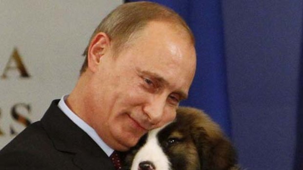 Russia's Prime Minister Vladimir Putin hugs a dog after receiving it as a present from Bulgaria's Prime Minister last month.
