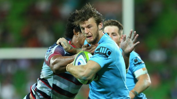 Chasing their best: Rob Horne of the Waratahs is tackled during the win over the Rebels last month.