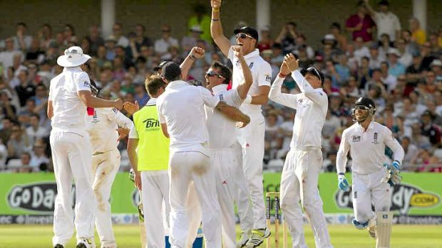 England's Graeme Swann celebrates with teammates after the video review system overturned a not out decision against Phillip Hughes.