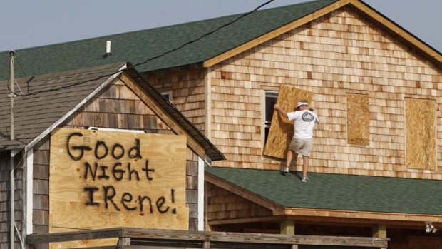 Race against time ... a man boards up a house as 200,000 North Carolina residents were ordered to leave after the storm earlier swept through the Bahamas.