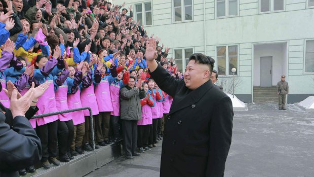 North Korean leader Kim Jong-un waves to a crowd in this state-supplied photo.
