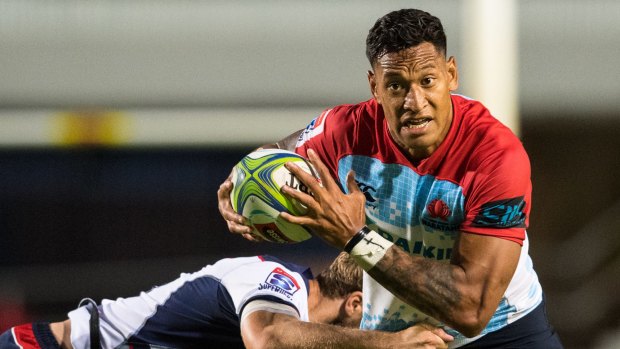 Israel Folau of the Waratahs takes on the Rebels defence in the recent trial game.