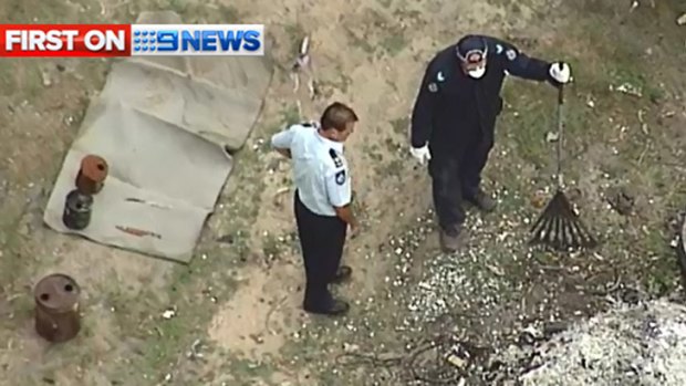 Police uncover knives and jerry cans at a crime scene off Chambers Flat Road in Logan Reserve. Photo: Nine News