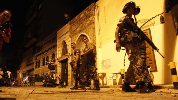 Street warfare ... Lebanese soldiers patrol outside a mosque in Beirut after fighting broke out between  Hezbollah and a Sunni group.