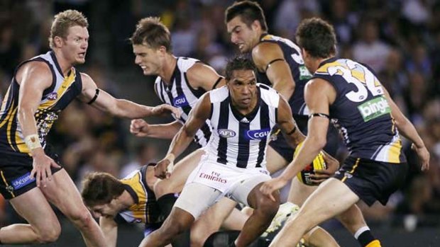 New Magpie Andrew Krakouer looks to charge through heavy traffic during Collingwood's comfortable victory against Richmond at Etihad Stadium last night.
