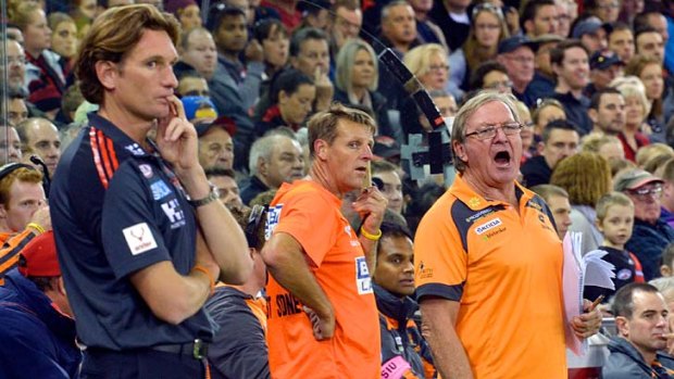 Essendon coach James Hird and his GWS counterpart Kevin Sheedy watch the game.