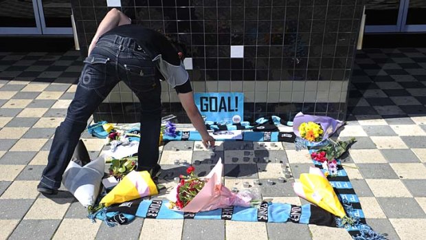 Flowers placed outside the Port Adelaide club in memory of John McCarthy.