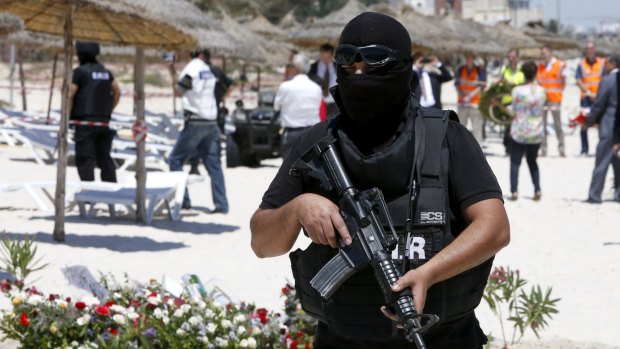 A hooded Tunisian police officer