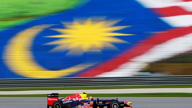 In top gear: Mark Webber steers his Red Bull around the Sepang circuit at the Malaysian Grand Prix yesterday.