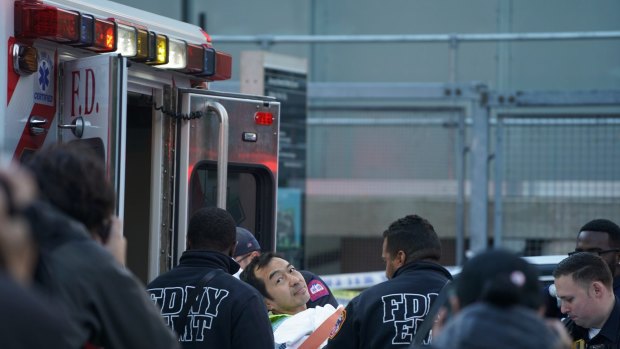 An injured man is loaded into an ambulance after a pickup truck struck multiple people in Lower Manhattan.