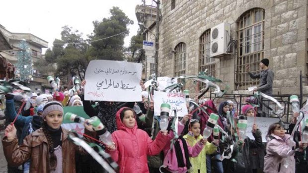 Young demonstrators chant slogans and hold banners in Zabadani.