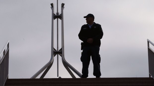 Lockdown: An Australian Federal Police officer at the ministerial entrance to Parliament House.