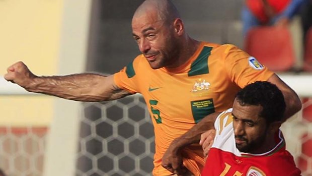 Sasa Ognenovski wins a header against Oman's Ismail Al Ajmi on Friday.