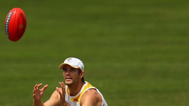 Trent Cotchin looks to mark during a training session yesterday.