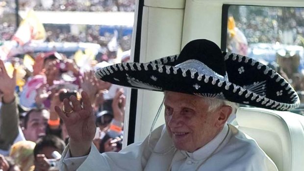 Pope Benedict, wearing a sombrero, is greeted by worshippers before an open air Mass in Mexico. In Cuba there are calls for the Church to condemn abuses.