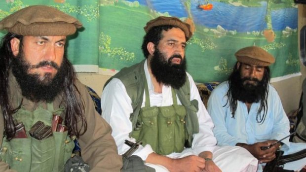 Shahidullah Shahid, centre, flanked by his bodyguards, talks to reporters at an undisclosed location in Pakistani tribal area of Waziristan.