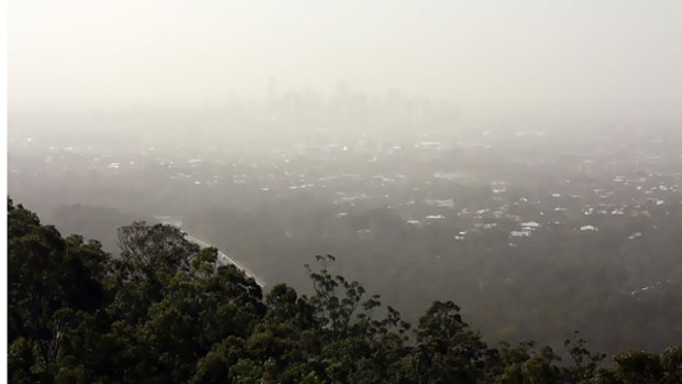 The Brisbane skyline disappears into a dust haze.