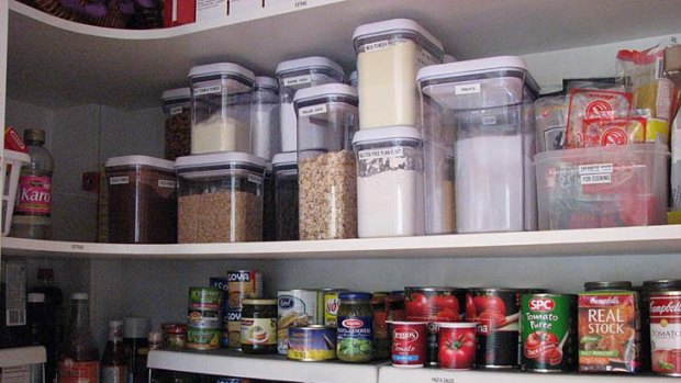 Pantry makeover ... Karen Koedding puts plastic containers, internal shelves and labels to good use for a client.