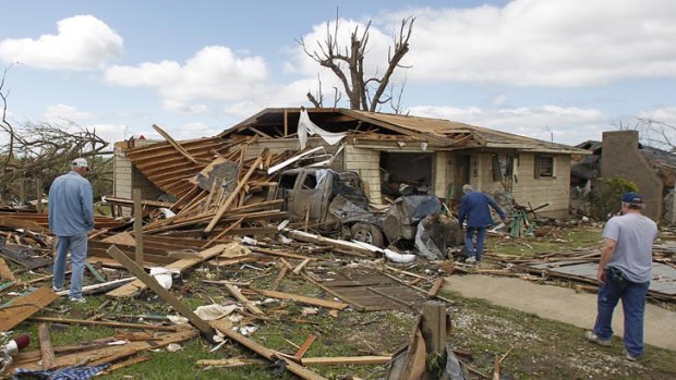 Residents search through what is left of their homes after a tornado hits Pleasant Grove.