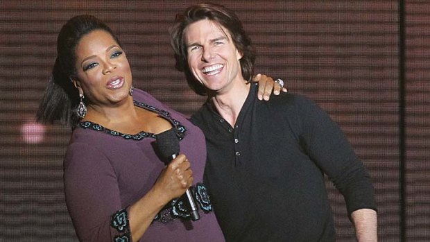 Tom Cruise on stage with Oprah Winfrey.
