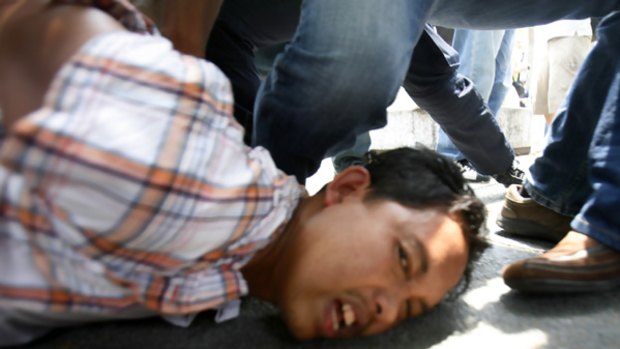 A man is arrested during a protest against the Internal Security Act in Kuala Lumpur.