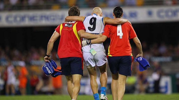 Gary Ablett of the Suns leaves the field after being injured during the round four game against the Brisbane Lions.