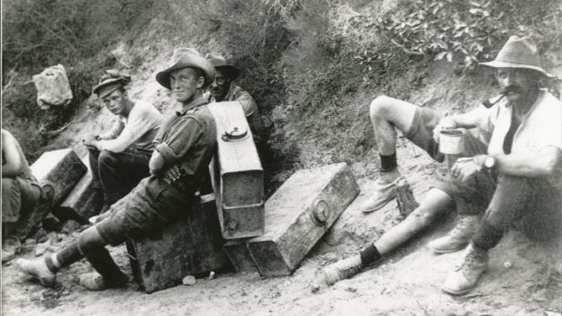 Men of the 6th Field Battery on water-carrying fatigues stop for a rest and a smoke.