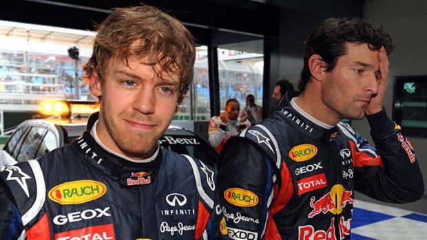 Sebastian Vettel (L) smiles after securing pole position with teammate Mark Webber (R).