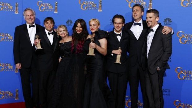The cast of <i>Boyhood</i> with their award for best motion picture - drama at the 72nd Golden Globe Awards.