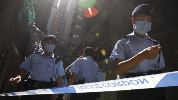 Hong Kong police seal off a hotel where a Mexican had been staying.