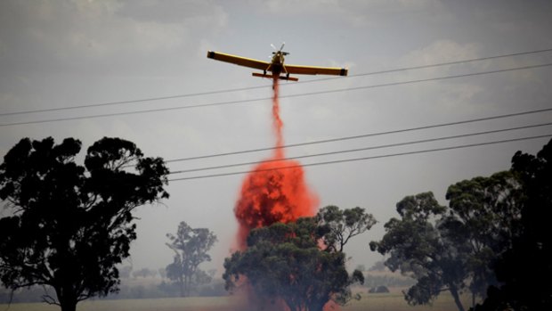 Copping a spray … a firefighting plane drops retardant on a blaze near Wagga Wagga airport.